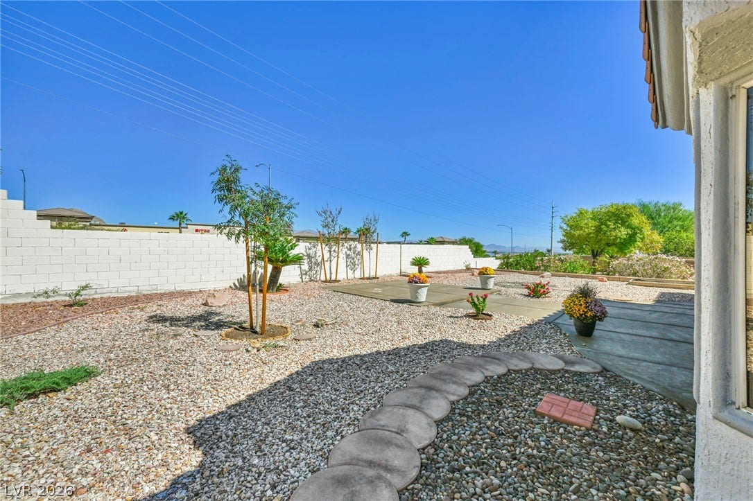 10020 Villa Ridge Drive, Las Vegas, NV 89134 Low-maintenance landscaping and paved walkways define this private outdoor space.