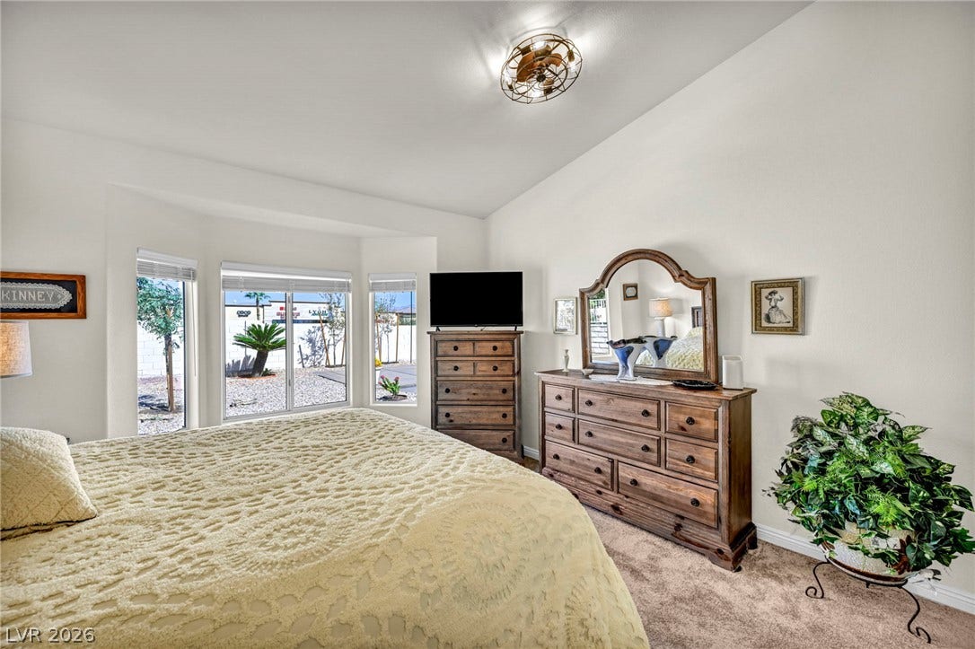 10020 Villa Ridge Drive, Las Vegas, NV 89134 Plentiful natural light streams through a bay window assembly onto soft carpeted flooring.