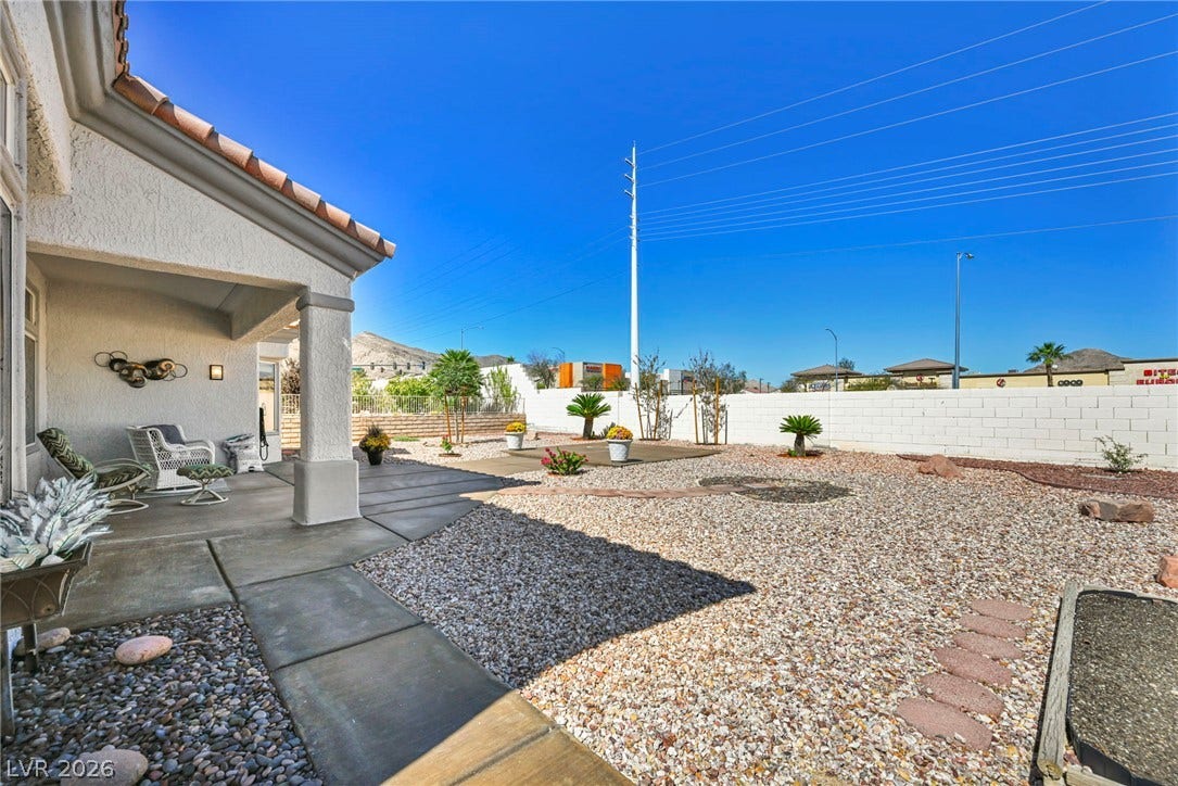 10020 Villa Ridge Drive, Las Vegas, NV 89134 A spacious covered patio overlooks a low-maintenance gravel yard enclosed by a block wall.