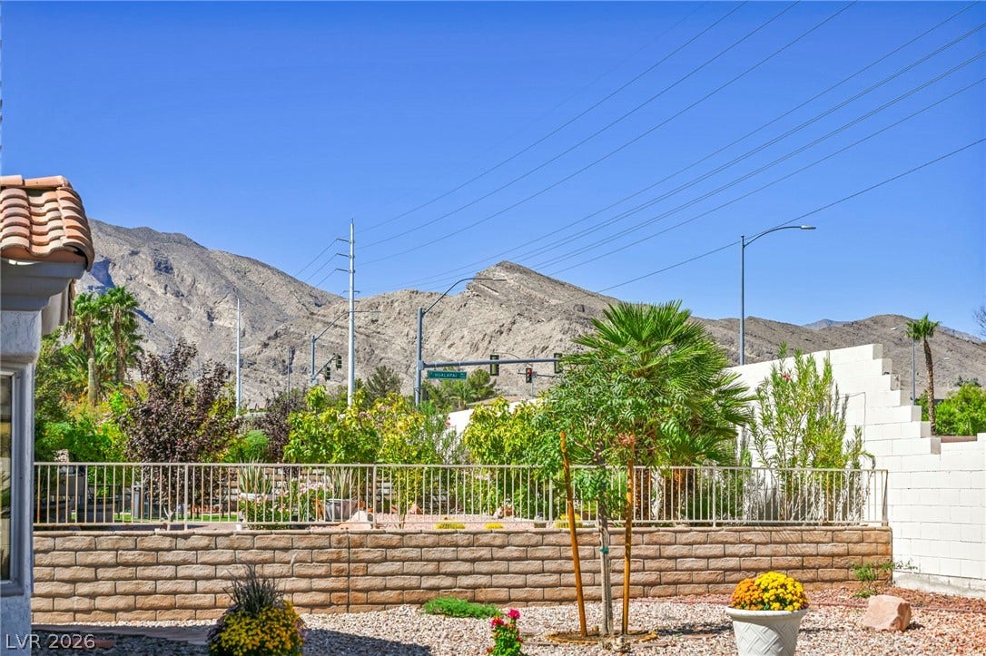 10020 Villa Ridge Drive, Las Vegas, NV 89134 Dramatic mountain peaks rise in the distance beyond the landscaped backyard fence.