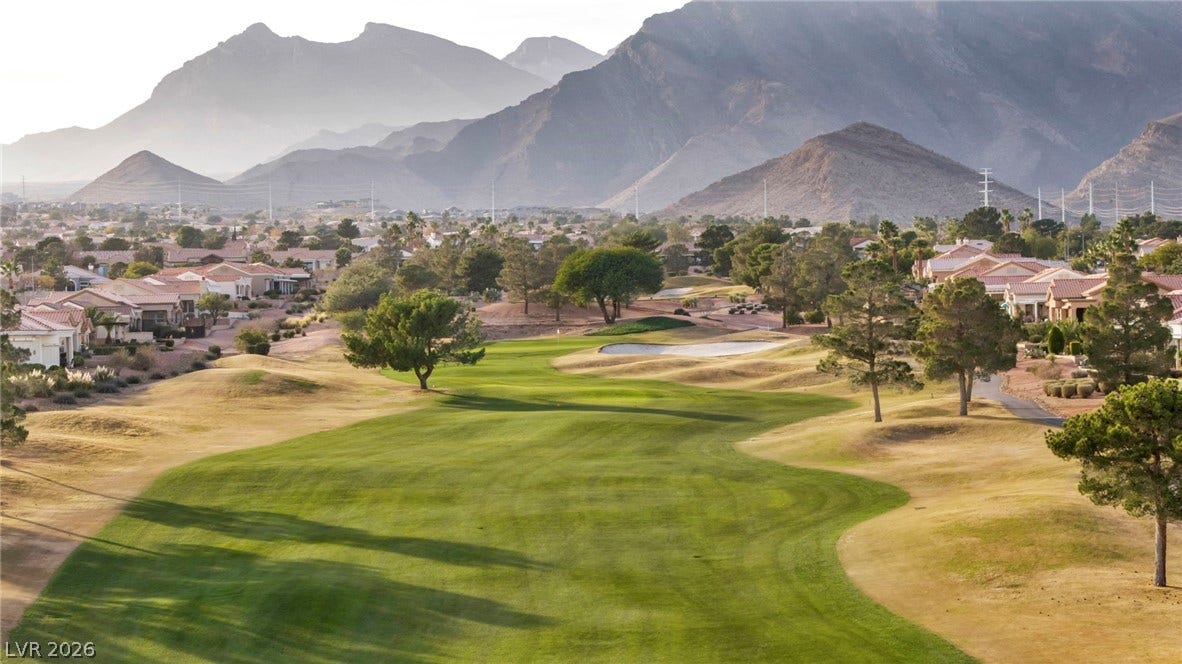 10020 Villa Ridge Drive, Las Vegas, NV 89134 Dramatic mountain peaks frame a beautifully manicured fairway winding past neighborhood residences.