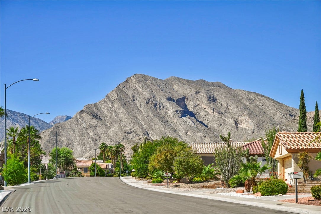 10020 Villa Ridge Drive, Las Vegas, NV 89134 Dramatic mountain peaks provide a striking natural backdrop above the peaceful suburban street.