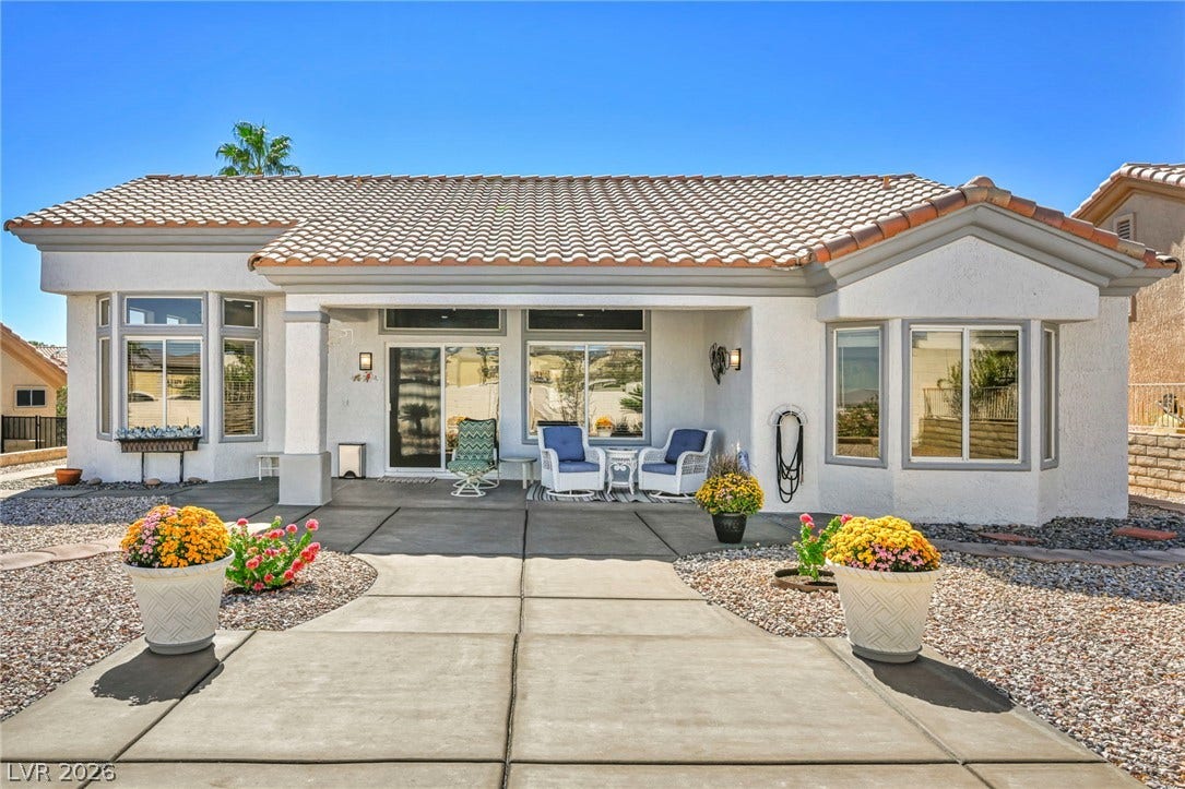 10020 Villa Ridge Drive, Las Vegas, NV 89134 A spacious concrete patio extends from the back of this stucco home under tile roofing.