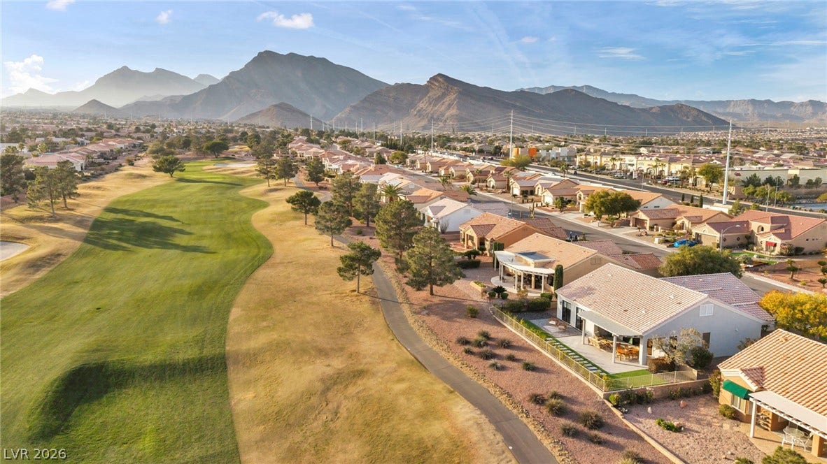 10020 Villa Ridge Drive, Las Vegas, NV 89134 Dramatic mountain ranges frame this tranquil desert community and its rolling green golf course lanes.