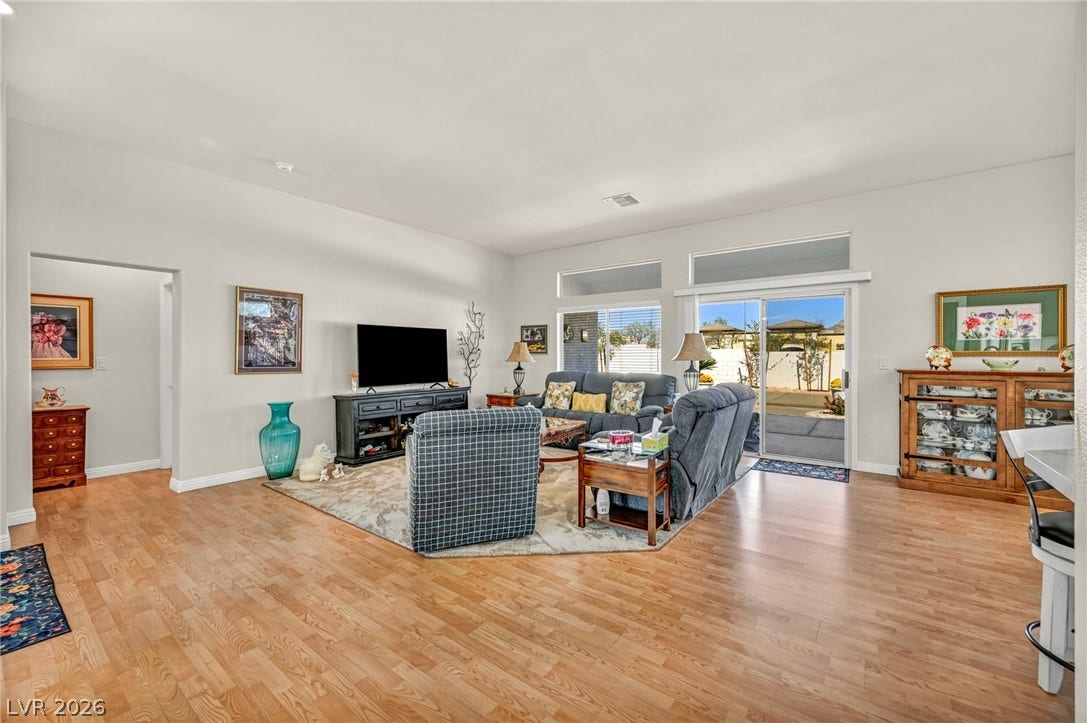 10020 Villa Ridge Drive, Las Vegas, NV 89134 Polished wood floors and sliding glass doors define this airy, open living area.