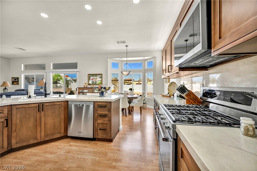 10020 Villa Ridge Drive, Las Vegas, NV 89134 Gleaming hardwood floors and recessed lighting enhance this airy culinary space with stone countertops.