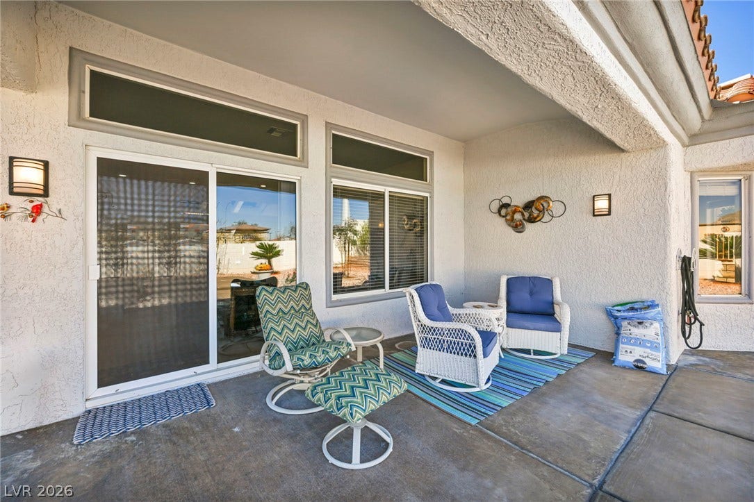 10020 Villa Ridge Drive, Las Vegas, NV 89134 Sliding glass doors open directly to a covered concrete patio ideal for outdoor relaxation.