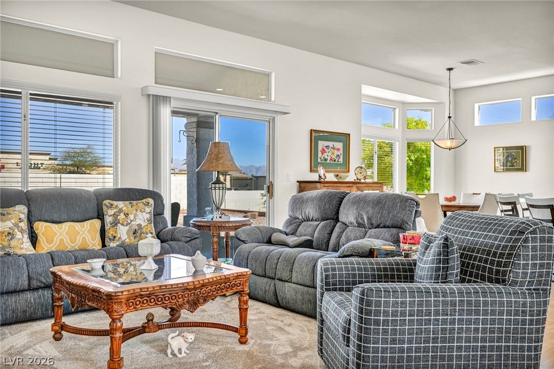 10020 Villa Ridge Drive, Las Vegas, NV 89134 Sunlight streams through high transom windows into an airy, open-concept living area.