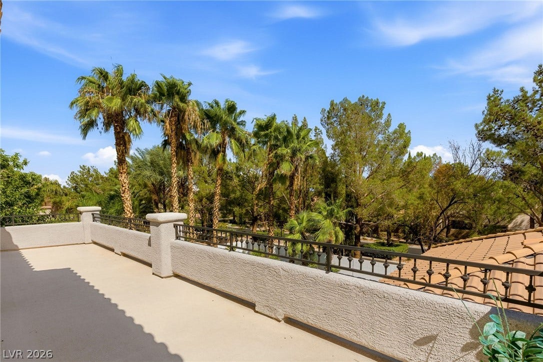10626 San Vercelli Court, Las Vegas, NV 89141 Scenic views of mature palm trees frame the concrete second-story balcony.