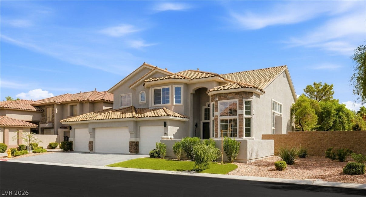 10626 San Vercelli Court, Las Vegas, NV 89141 A classic tiled roof and arched entryway define this grand two-story suburban residence.