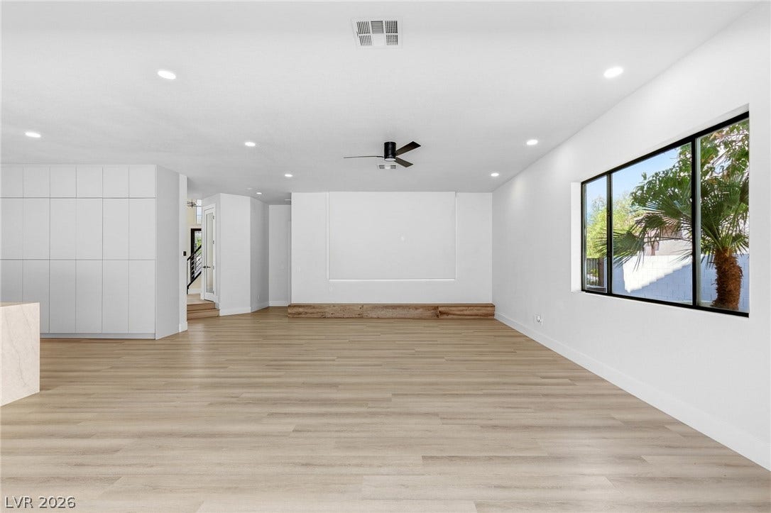 10626 San Vercelli Court, Las Vegas, NV 89141 Rich wood-look flooring and clean lines define this expansive, modern living space.