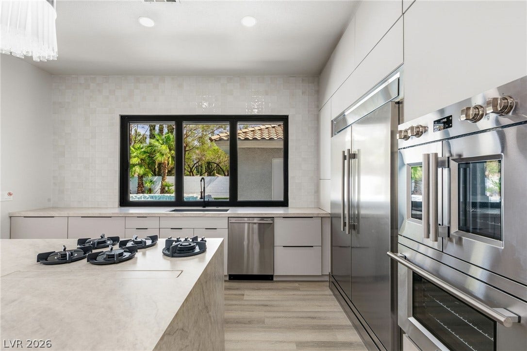 10626 San Vercelli Court, Las Vegas, NV 89141 Streamlined cabinetry and high-end stainless steel appliances define this modern kitchen space.