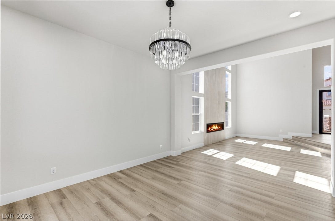 10626 San Vercelli Court, Las Vegas, NV 89141 Elegant wood floors and a modern linear fireplace enrich this open concept layout.