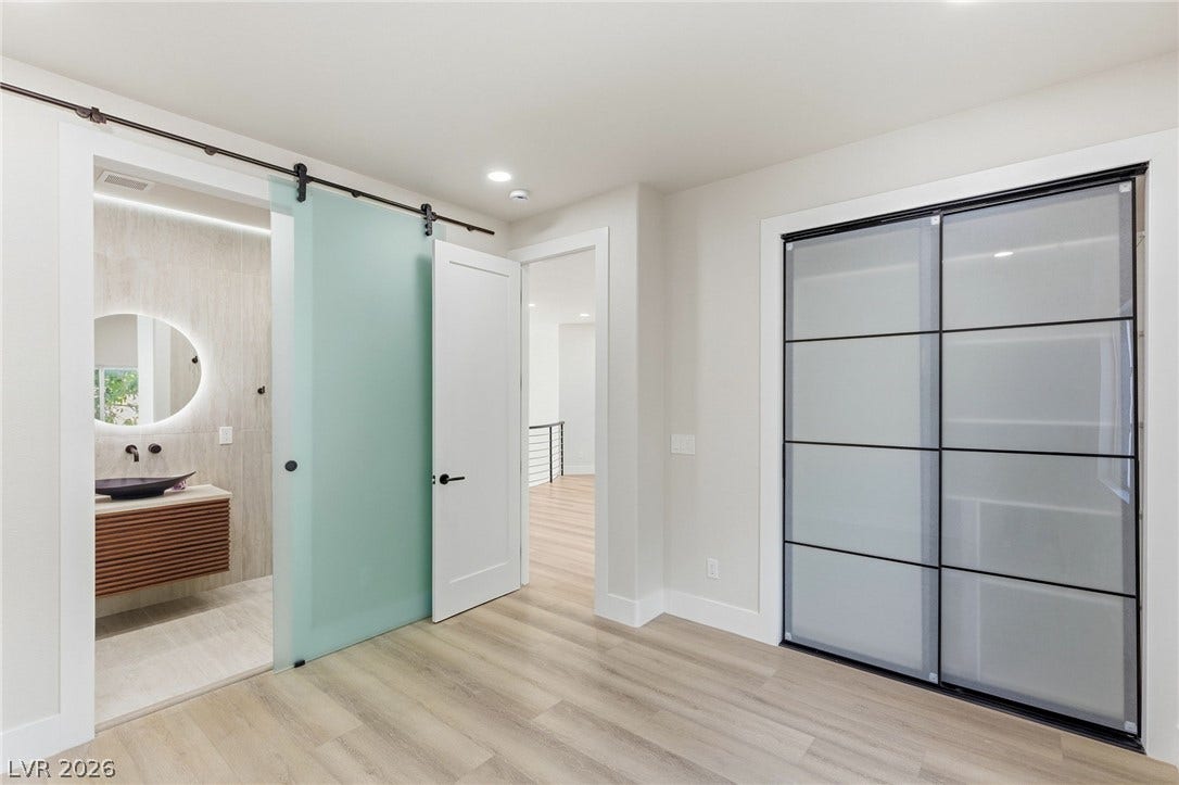 10626 San Vercelli Court, Las Vegas, NV 89141 Gleaming wood floors pair with clean lines and custom sliding glass doors.