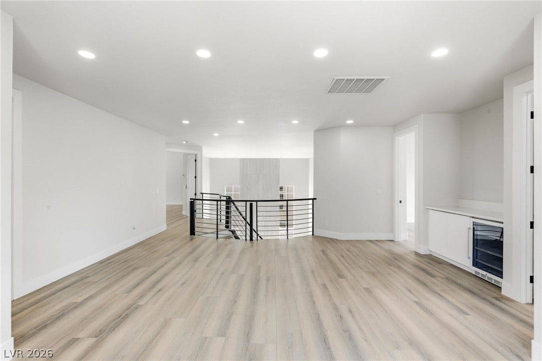 10626 San Vercelli Court, Las Vegas, NV 89141 An open upstairs landing features wide plank flooring, recessed lighting, and a built-in wet bar.