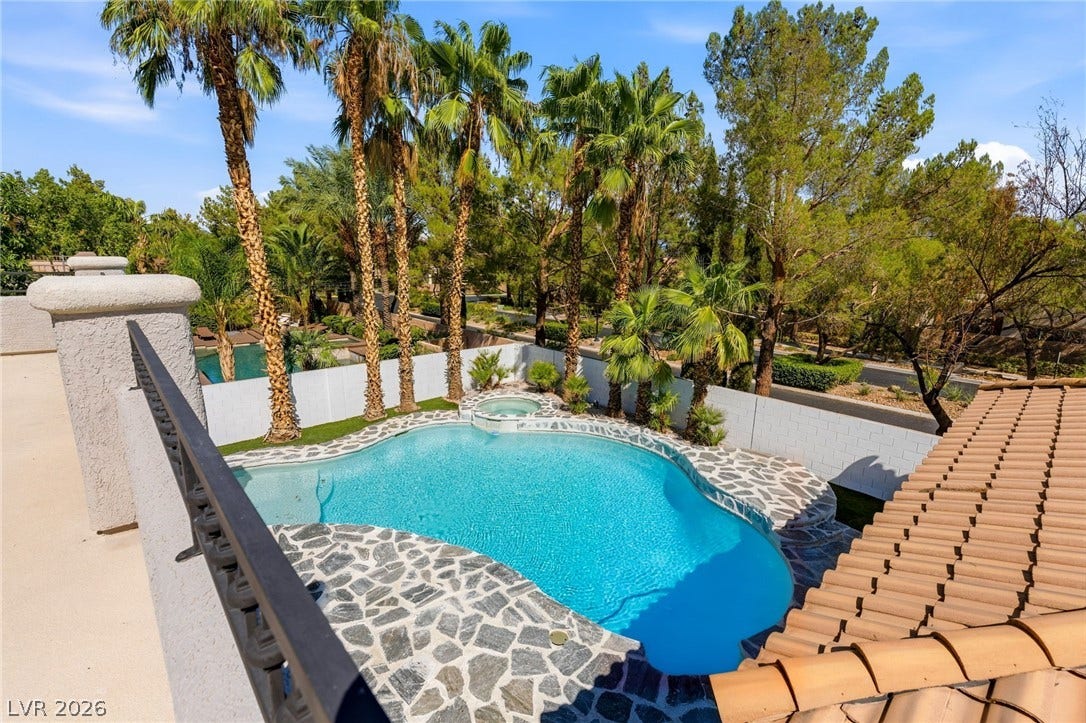 10626 San Vercelli Court, Las Vegas, NV 89141 An aerial perspective reveals a sparkling backyard swimming pool lined with natural stone decking.