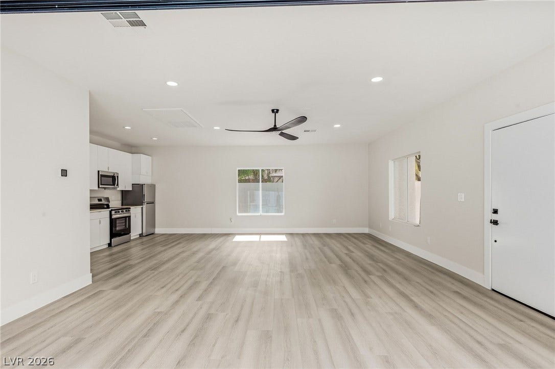 10626 San Vercelli Court, Las Vegas, NV 89141 Clean lines and durable plank flooring define this versatile open-concept living area.