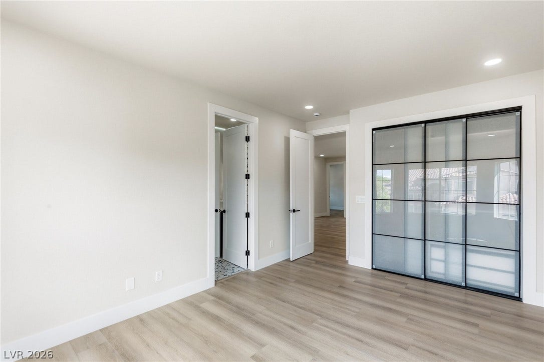 10626 San Vercelli Court, Las Vegas, NV 89141 Sleek sliding glass closet doors and wood floors anchor this clean interior space.