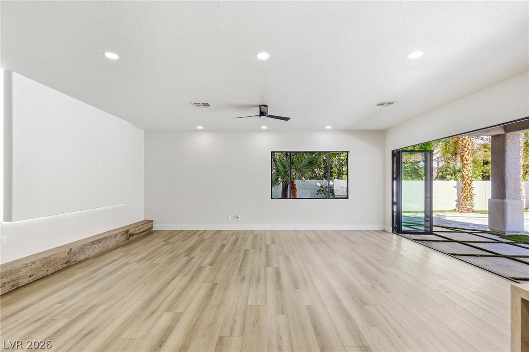 10626 San Vercelli Court, Las Vegas, NV 89141 Smooth wood floors and recessed lighting anchor this airy living space opening to the outdoors.