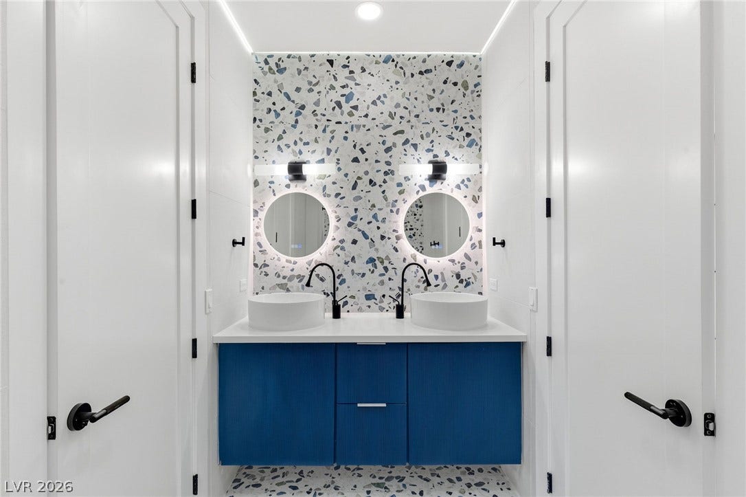 10626 San Vercelli Court, Las Vegas, NV 89141 A contemporary double vanity stands out against vibrant patterned tiling.