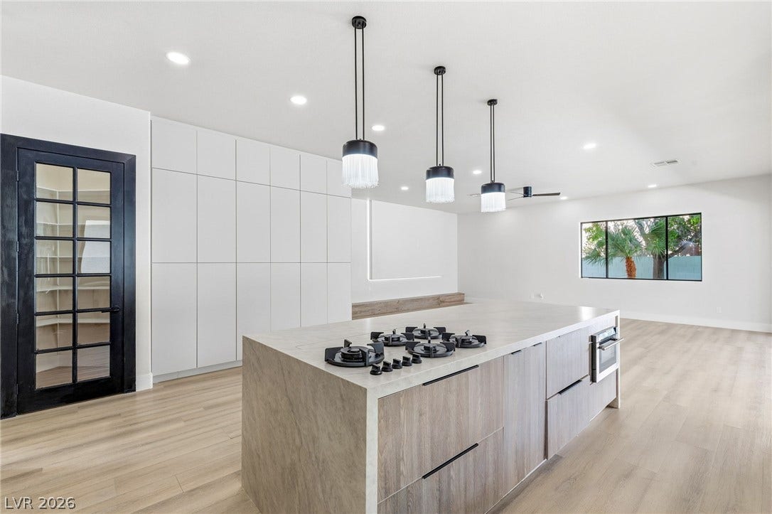 10626 San Vercelli Court, Las Vegas, NV 89141 Minimalist design elements highlight this modern culinary space anchored by a waterfall island.