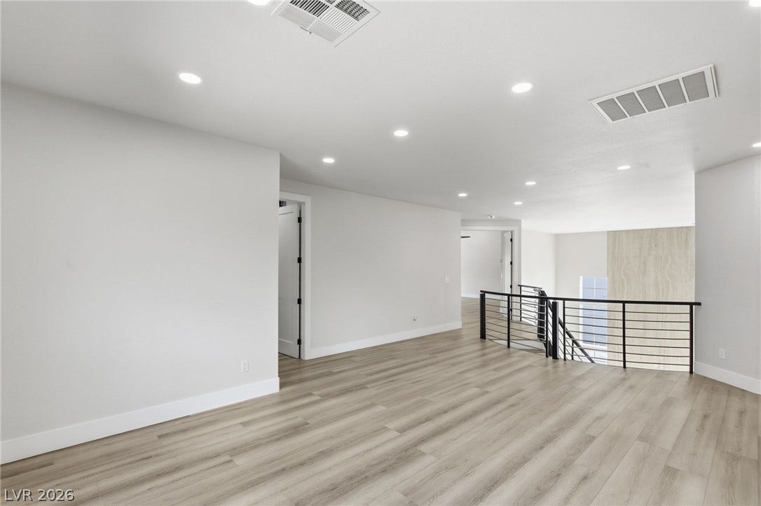 10626 San Vercelli Court, Las Vegas, NV 89141 Clean lines and smooth flooring define this versatile upstairs loft overlooking the lower level.