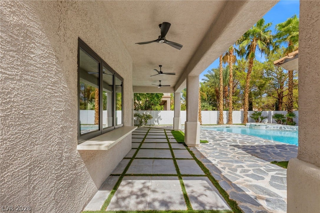 10626 San Vercelli Court, Las Vegas, NV 89141 An inviting covered patio steps out to a sparkling pool surrounded by palm trees.