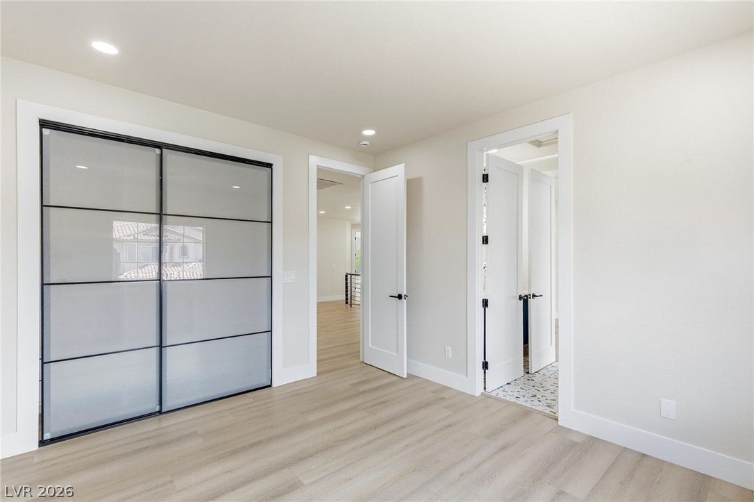 10626 San Vercelli Court, Las Vegas, NV 89141 Sleek contemporary doors and modern wood-style flooring elevate this serene private retreat.