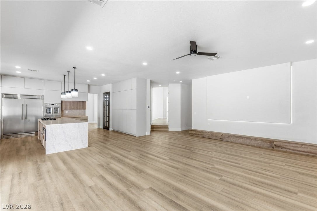 10626 San Vercelli Court, Las Vegas, NV 89141 Gleaming wood floors anchor a spacious open layout under soaring ceilings.