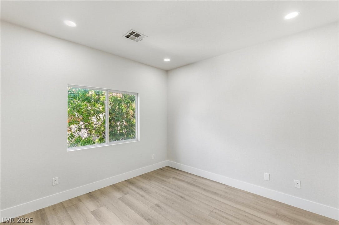 10626 San Vercelli Court, Las Vegas, NV 89141 Recessed lighting and wood-inspired flooring elevate this versatile, light-filled bedroom space.