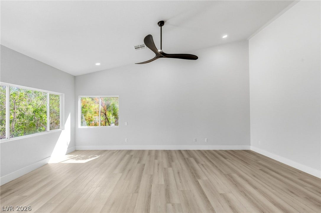 10626 San Vercelli Court, Las Vegas, NV 89141 Angled ceilings and wide wood-plank flooring create a serene, minimalist retreat filled with natural light.