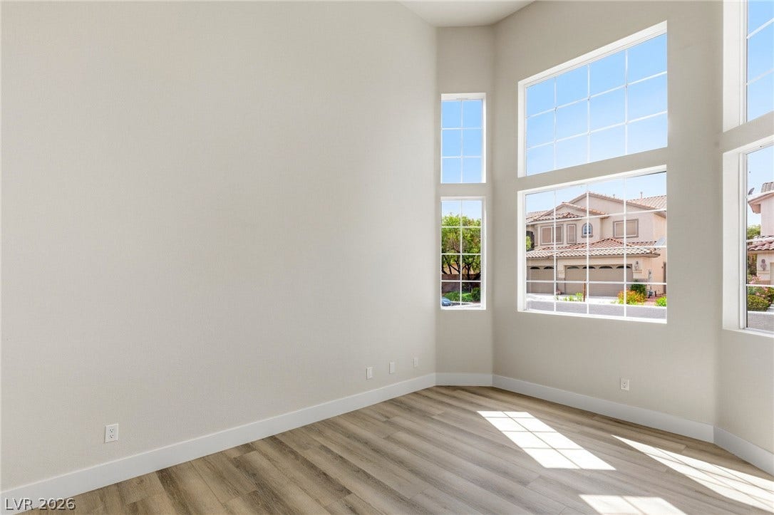 10626 San Vercelli Court, Las Vegas, NV 89141 High ceilings and tall multi-pane windows elevate this versatile interior space.