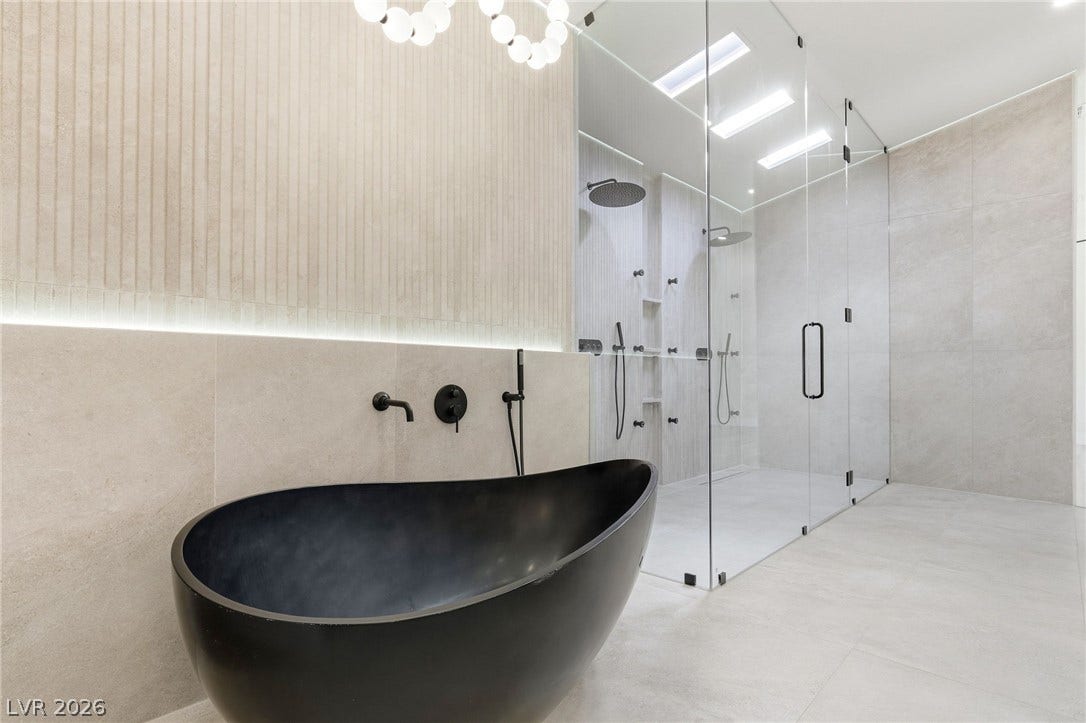 10626 San Vercelli Court, Las Vegas, NV 89141 Minimalist design shines with a sleek freestanding tub and a massive glass shower enclosure.