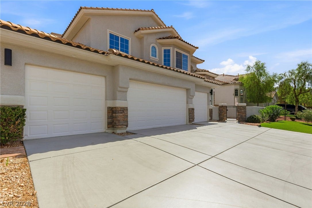 10626 San Vercelli Court, Las Vegas, NV 89141 Multi-car garages fronted by an expansive concrete driveway lead toward a charming gated entryway.