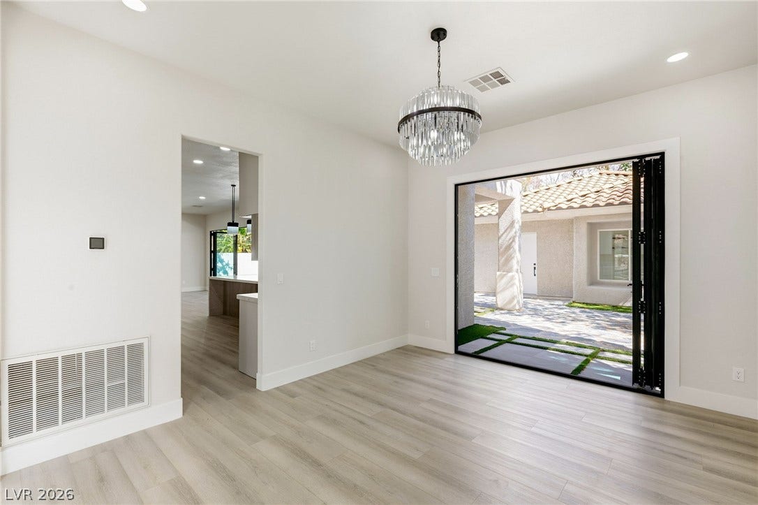 10626 San Vercelli Court, Las Vegas, NV 89141 Smooth flooring and broad sliding glass doors connect this space with the courtyard outside.