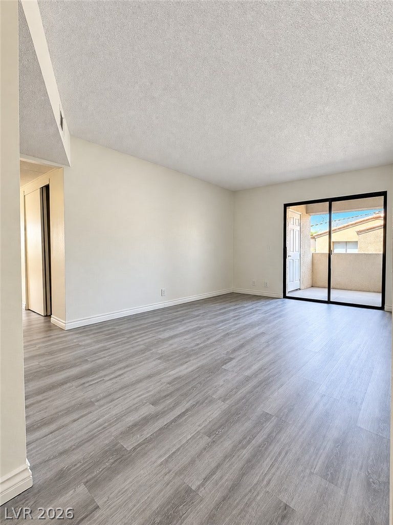 Sliding glass doors open directly to a private balcony from this spacious living area.