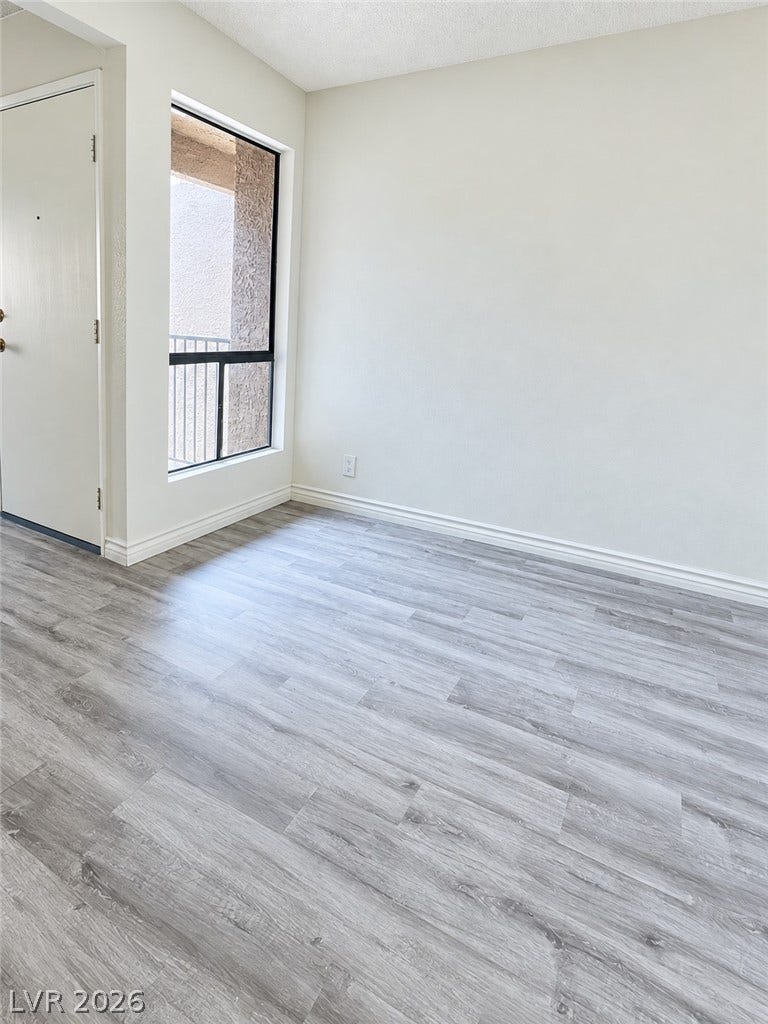 Modern plank flooring and crisp trim highlight this versatile living area.