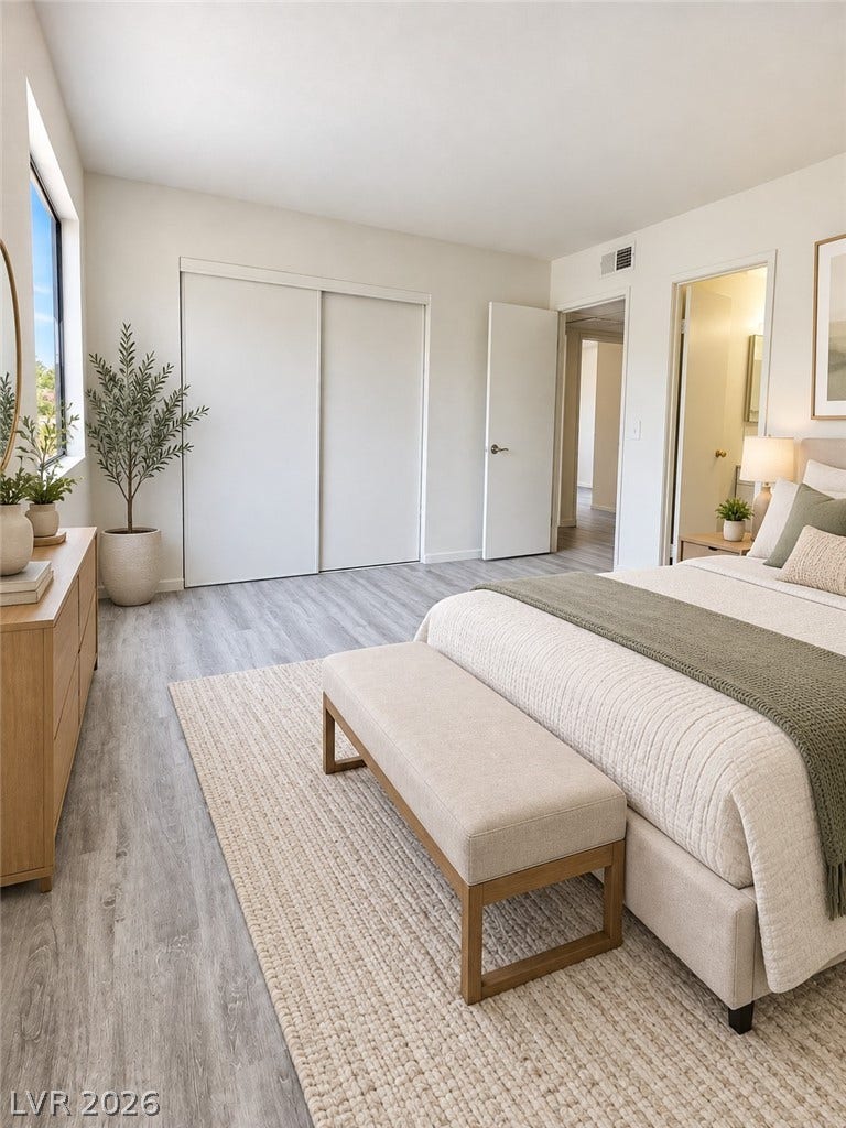 Virtually Staged Smooth wood-plank flooring pairs with neutral walls in this comfortable bedroom space.