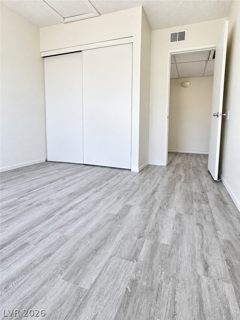 Modern plank flooring runs throughout this versatile interior space with ample closet storage.