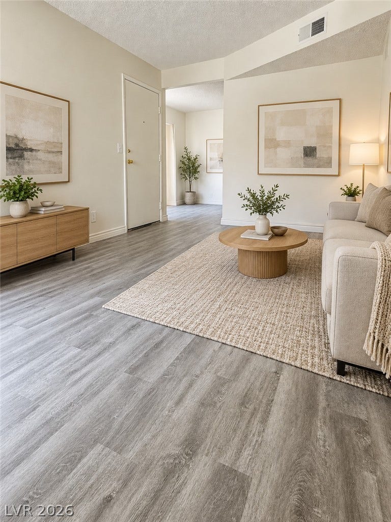 Virtually Staged 
An open main floor area highlights durable vinyl plank flooring and tall ceilings.