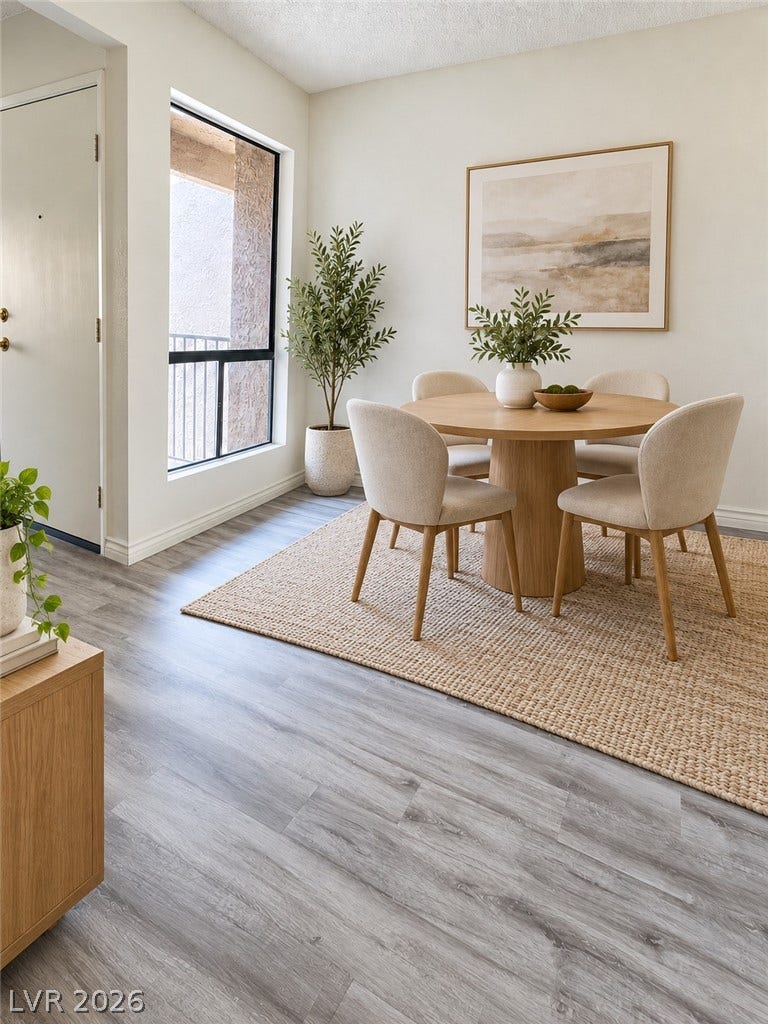 Virtually Staged 
An inviting dining space features wood flooring and a large window looking out to the patio.