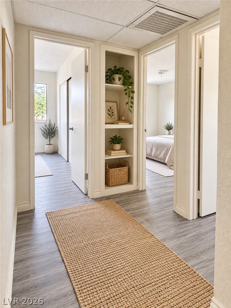 Virtually Staged Smartly designed built-in shelving optimizes storage in this hallway connecting several light-filled bedrooms.