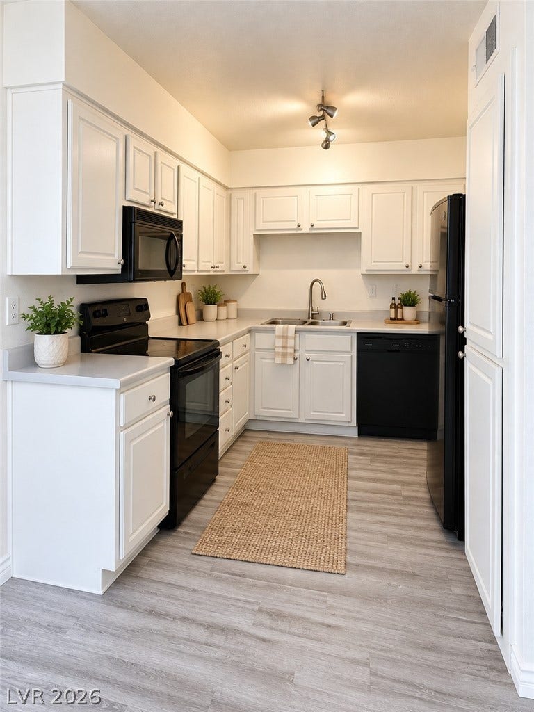 Virtually Staged Smooth wood-look flooring and clean white cabinetry define this highly functional kitchen layout.