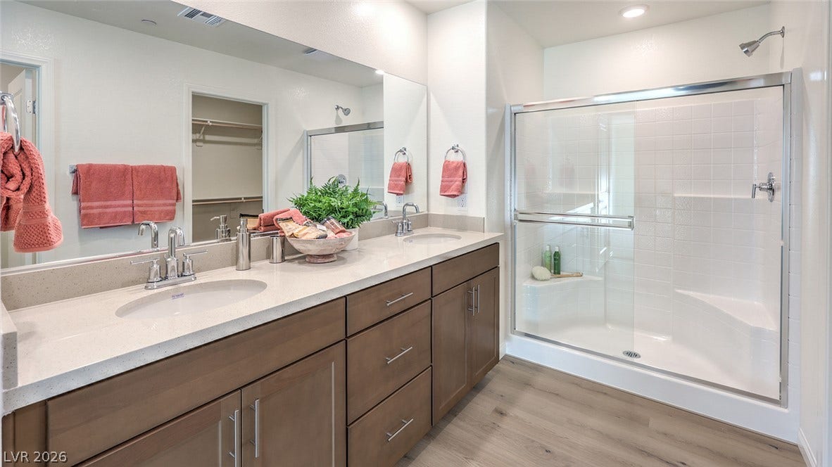 568 Ivory Peacock Ct, Henderson, NV 89011 Clean lines and a spacious dual vanity highlight this modern bathroom design.