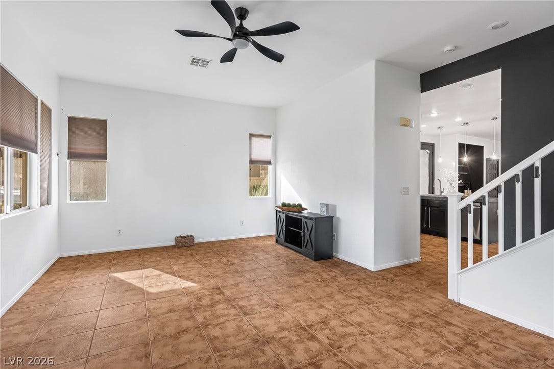 688 Canfield Point Avenue, Las Vegas, NV 89183 Warm tile flooring runs throughout this versatile living area featuring tall ceilings and natural light.