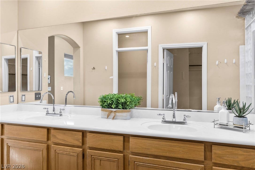 688 Canfield Point Avenue, Las Vegas, NV 89183 A spacious bathroom vanity offers ample storage space and a large mirrored wall.