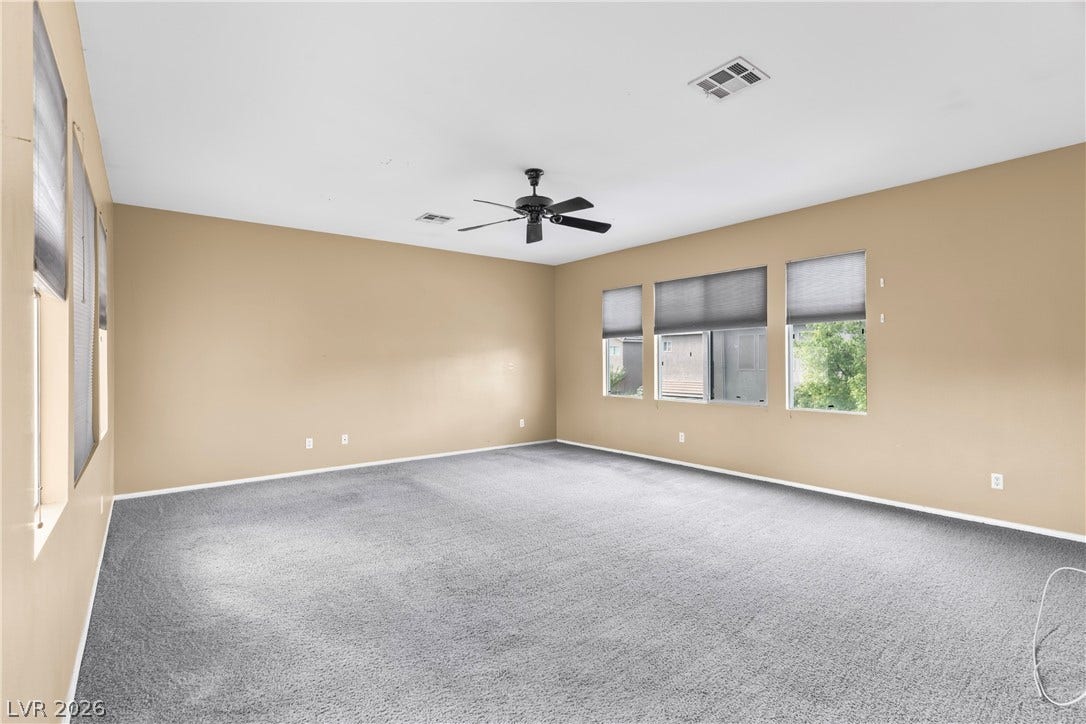 688 Canfield Point Avenue, Las Vegas, NV 89183 An open and versatile secondary bedroom features plush wall-to-wall carpeting and multiple large windows.
