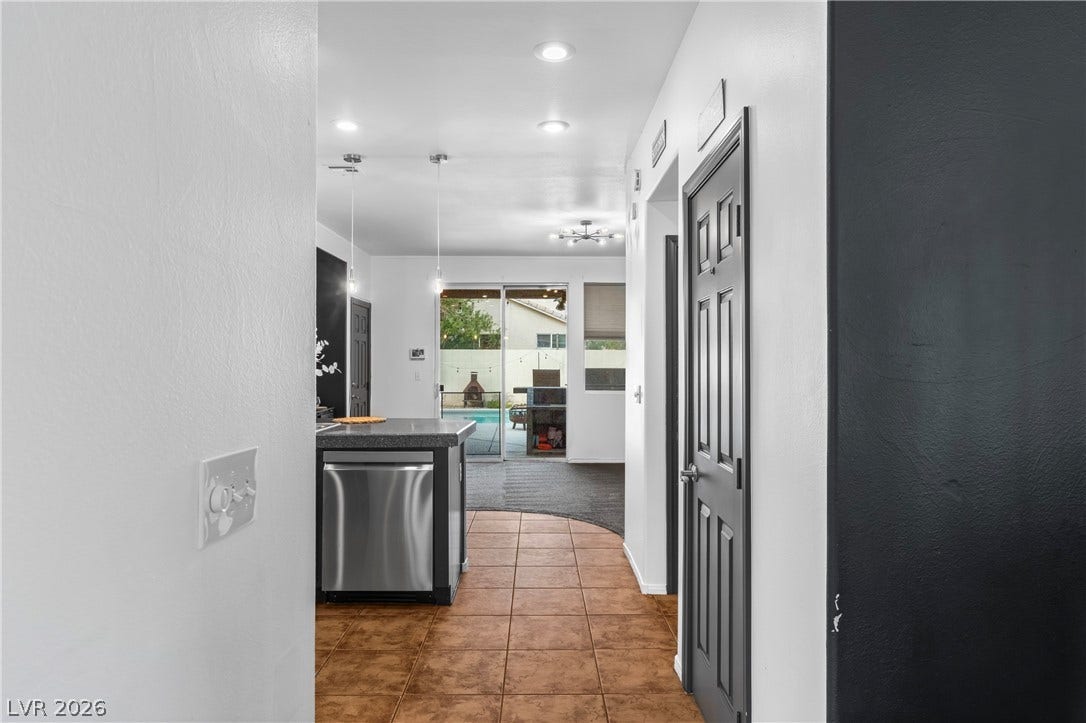 688 Canfield Point Avenue, Las Vegas, NV 89183 Tile flooring guides the way toward an open layout with a view of the pool.