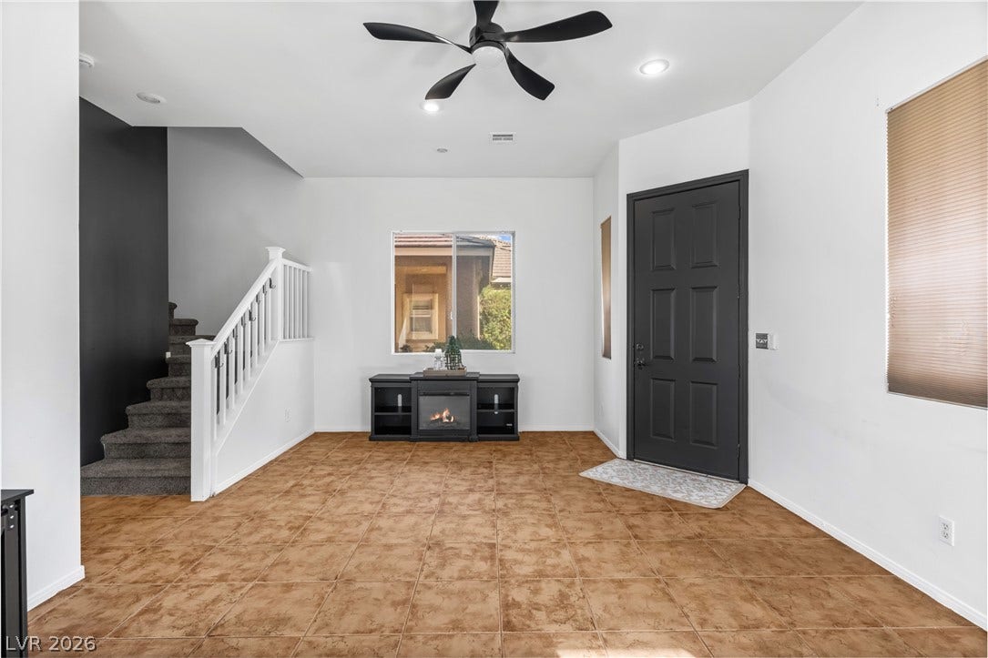 688 Canfield Point Avenue, Las Vegas, NV 89183 Earthy floor tiles underfoot welcome guests into this open entryway accented by a prominent staircase.
