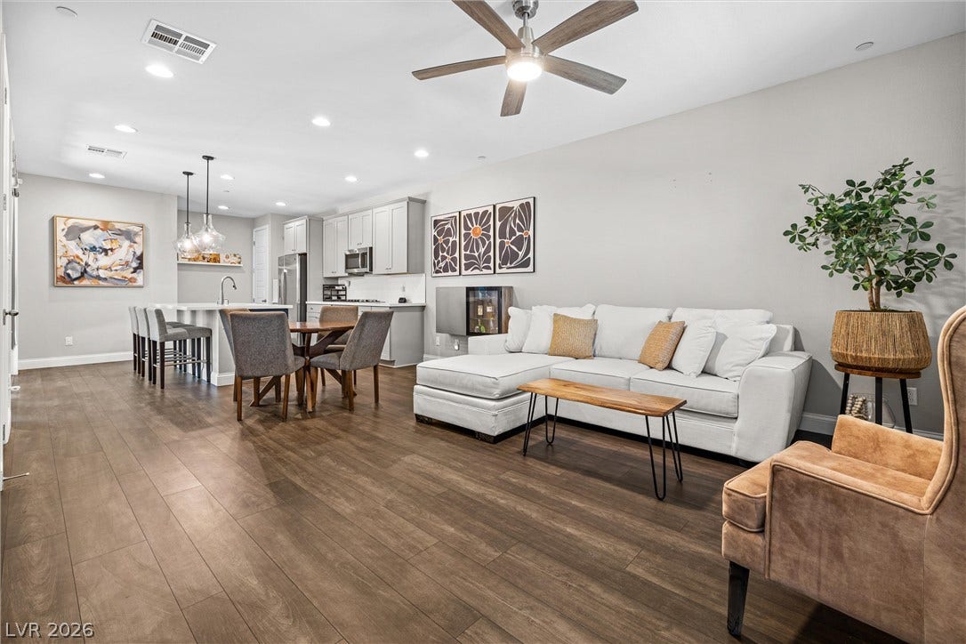 44 Kimberlite Drive, Henderson, NV 89011 This open concept living area seamlessly blends the kitchen, dining, and family room for modern living.